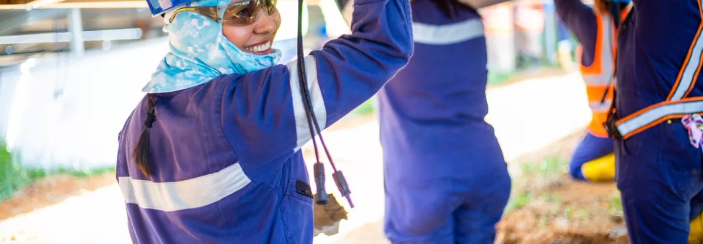 people - smiling worker in hard hat with others colombia