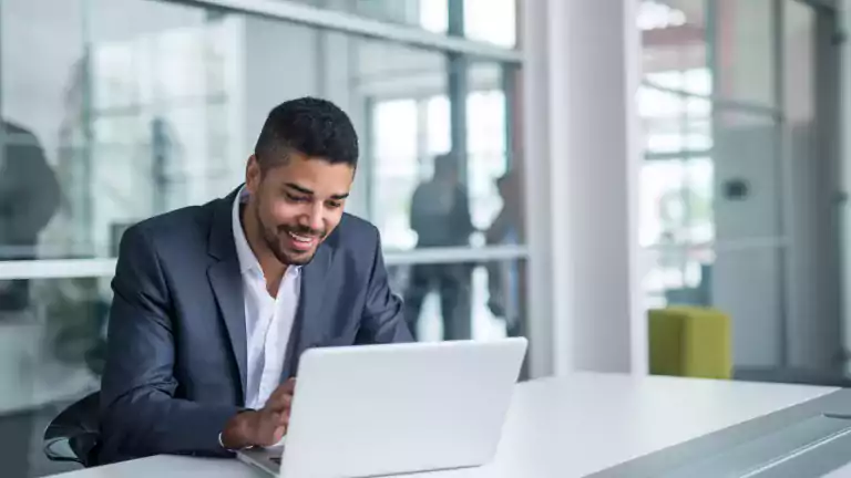 Man at desk making payment